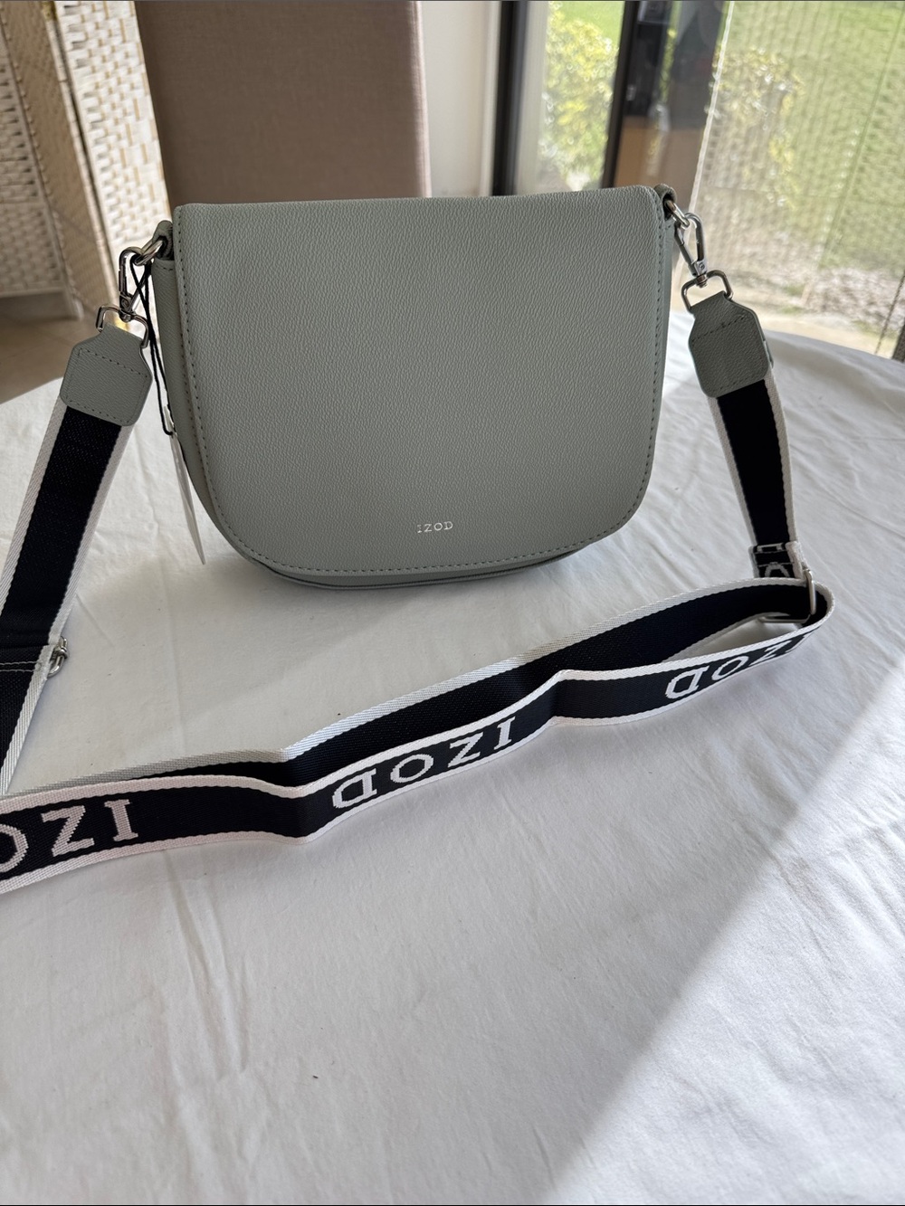 Izod Sage Pebbled Saddle Crossbody with Branded Strap